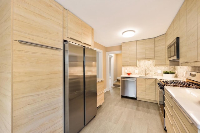 50 S Marquette St, Madison, WI 53704 - kitchen featuring appliances with stainless steel finishes, light brown cabinetry, light countertops, modern cabinets, and light wood-type flooring