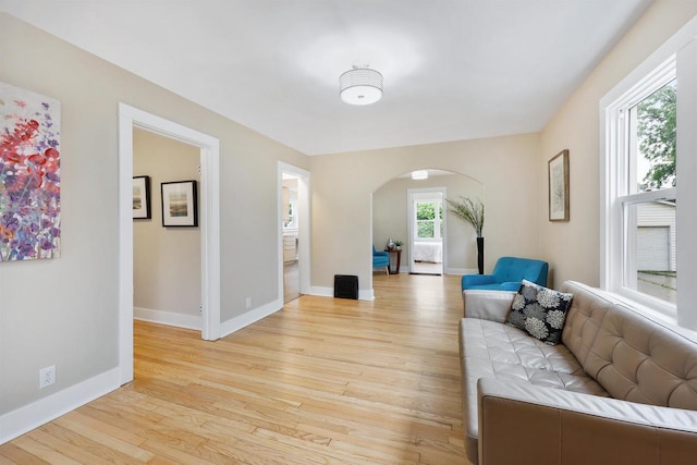 50 S Marquette St, Madison, WI 53704 - living area featuring arched walkways and light wood-style flooring