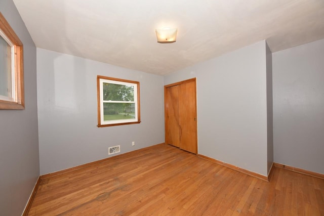8535 N 59th St, Brown Deer, WI 53223 - unfurnished bedroom featuring light wood-style flooring and a closet