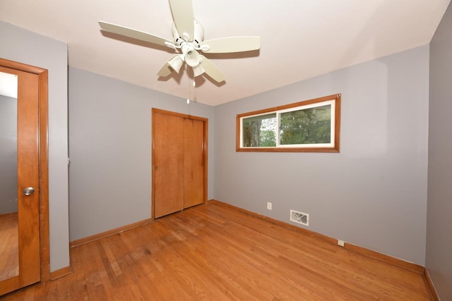 8535 N 59th St, Brown Deer, WI 53223 - unfurnished bedroom featuring light wood-style flooring, a closet, and a ceiling fan