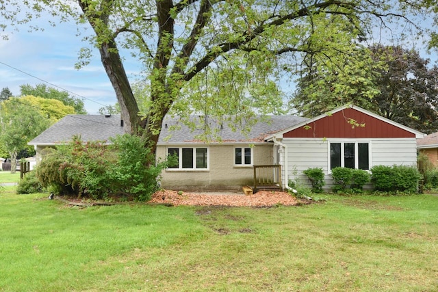 8535 N 59th St, Brown Deer, WI 53223 - rear view of property featuring a lawn and roof with shingles