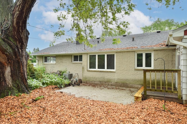 8535 N 59th St, Brown Deer, WI 53223 - rear view of property with a shingled roof and brick siding