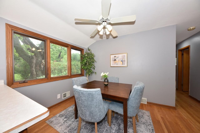 8535 N 59th St, Brown Deer, WI 53223 - dining space featuring light wood-style flooring, vaulted ceiling, and a ceiling fan