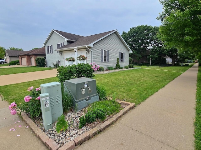 3201 Mockingbird Way, Oshkosh, WI 54904 - view of side of home featuring a yard, a garage, and driveway