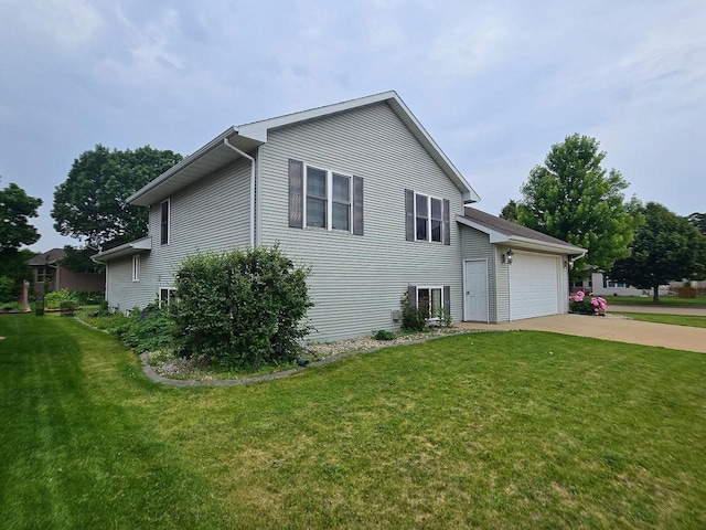 3201 Mockingbird Way, Oshkosh, WI 54904 - view of property exterior featuring concrete driveway, a lawn, and a garage
