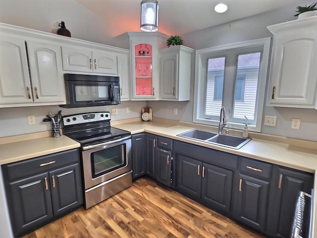 3201 Mockingbird Way, Oshkosh, WI 54904 - kitchen featuring black microwave, electric stove, white cabinetry, and light wood-type flooring