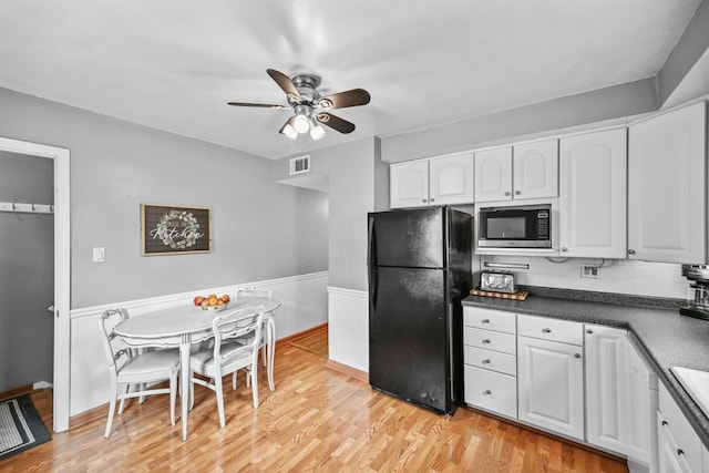2750 N 86th St, Milwaukee, WI 53222 - kitchen featuring freestanding refrigerator, built in microwave, ceiling fan, white cabinets, and light wood-style floors