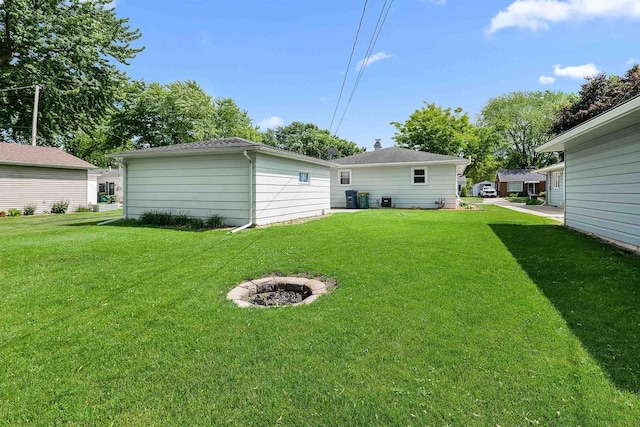 605 E 10th St, Fond Du Lac, WI 54935 - view of grassy yard featuring a fire pit