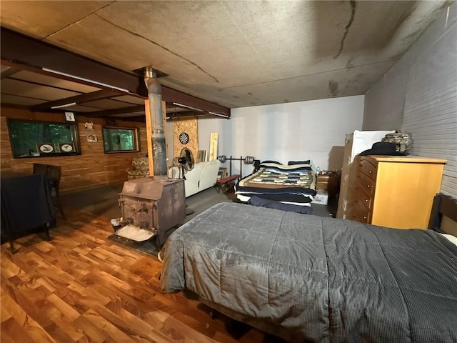 1330A 21 3/4 St, Cameron, WI 54822 - bedroom featuring wood finished floors, wood walls, and a wood stove