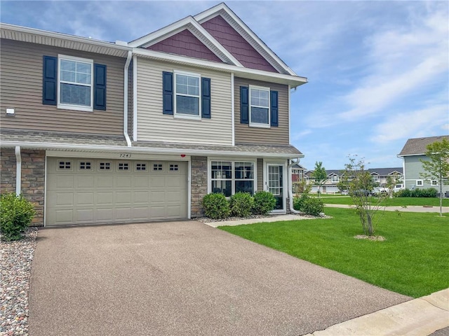7243 Fall Dr, Hugo, MN 55038 - view of property with driveway, stone siding, a front lawn, and an attached garage