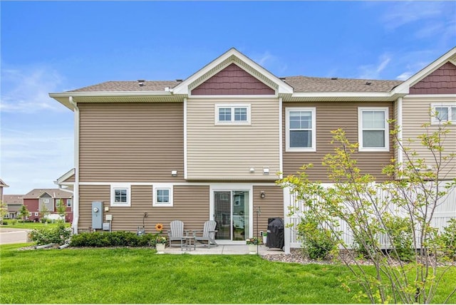 7243 Fall Dr, Hugo, MN 55038 - back of house featuring a patio and a lawn