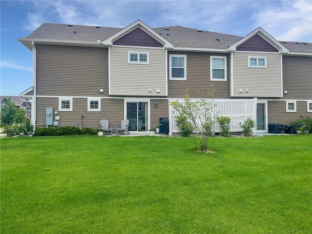 7243 Fall Dr, Hugo, MN 55038 - back of property featuring a lawn, a patio, and a shingled roof