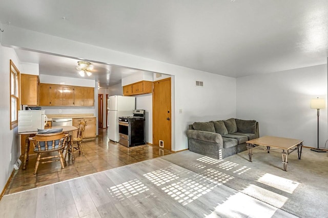 1128 S 62nd St, West Allis, WI 53214 - living room featuring light wood-style flooring and baseboards