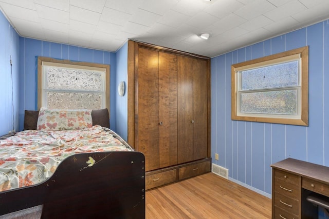 1002 Grove St, Oshkosh, WI 54901 - bedroom featuring light wood-type flooring and multiple windows