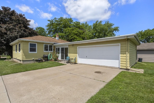 1002 Grove St, Oshkosh, WI 54901 - view of front of home with a front lawn, driveway, an attached garage, and a chimney