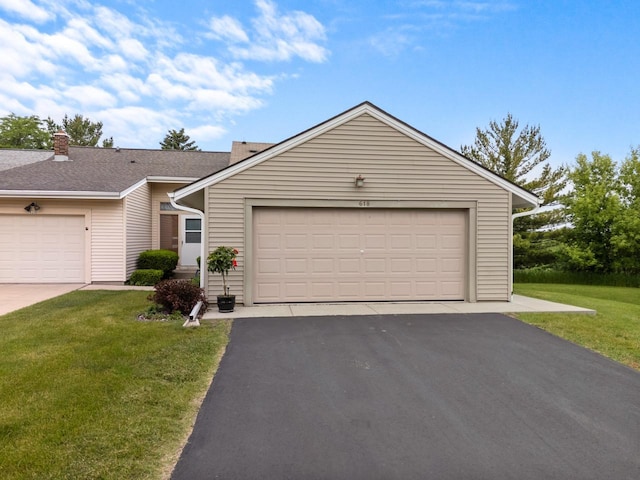 618 Westridge Dr, West Bend, WI 53095 - view of front facade with a front lawn, a garage, and driveway
