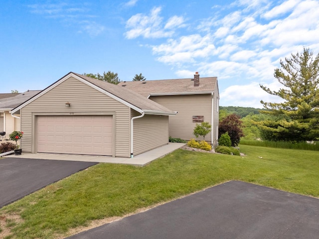 618 Westridge Dr, West Bend, WI 53095 - view of front of house featuring a chimney, driveway, a front yard, and a garage