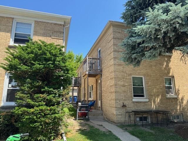 2703 N 69th St, Milwaukee, WI 53210 - view of home's exterior with a balcony and brick siding