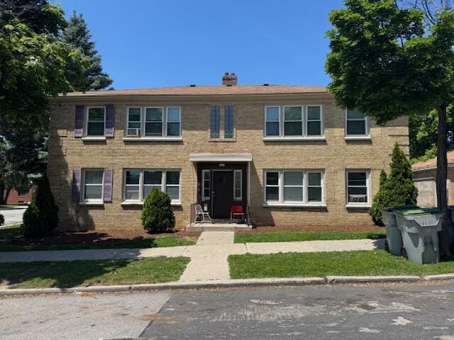 2703 N 69th St, Milwaukee, WI 53210 - view of front facade featuring a chimney and brick siding