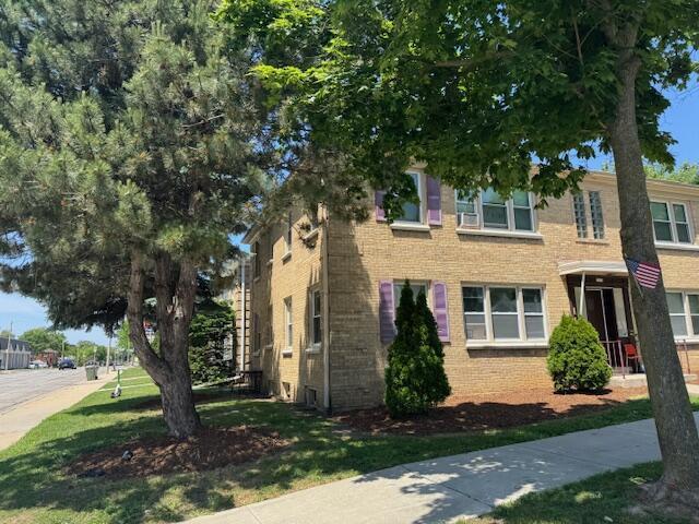 2703 N 69th St, Milwaukee, WI 53210 - view of front of home featuring brick siding and a front lawn