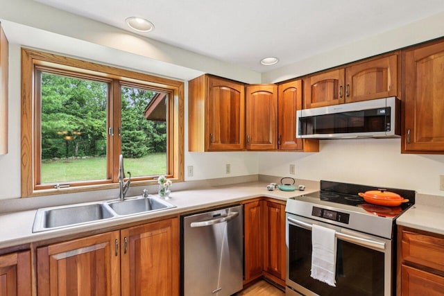W318S4121 Highview Rd, Waukesha, WI 53189 - kitchen featuring appliances with stainless steel finishes, light countertops, brown cabinets, and recessed lighting