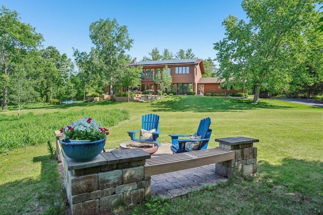 W318S4121 Highview Rd, Waukesha, WI 53189 - view of grassy yard featuring an outdoor fire pit and a patio