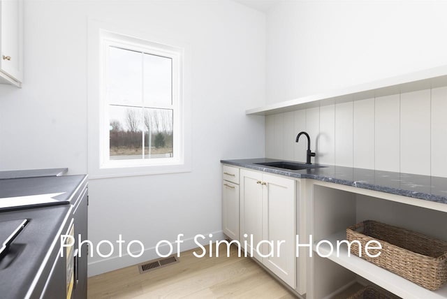 2584 N Stellita Cir, De Pere, WI 54115 - laundry area featuring a sink and light wood finished floors