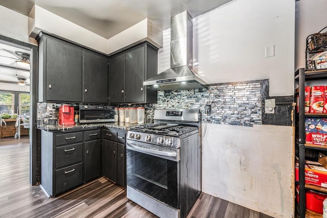 500 S Pierce Ave, Appleton, WI 54914 - kitchen with gas stove, wall chimney exhaust hood, dark wood-type flooring, backsplash, and dark cabinetry
