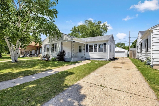 2316 W Rohr Ave, Milwaukee, WI 53209 - view of front of home featuring covered porch, a front lawn, a detached garage, and an outbuilding