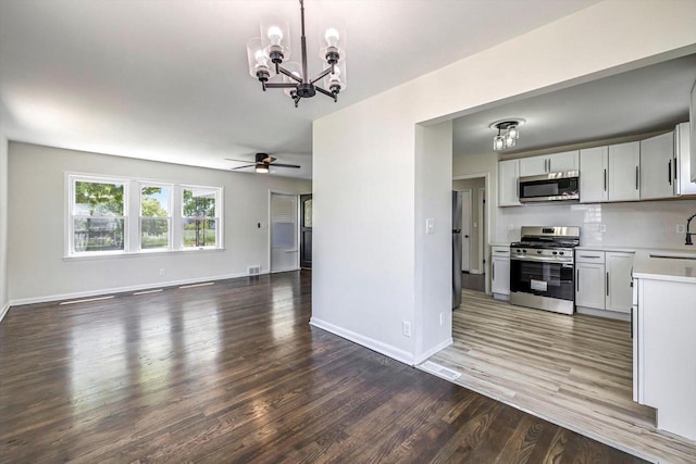 2316 W Rohr Ave, Milwaukee, WI 53209 - kitchen with stainless steel appliances, a chandelier, open floor plan, light countertops, and wood finished floors