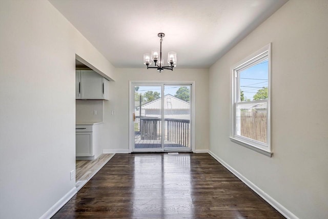 2316 W Rohr Ave, Milwaukee, WI 53209 - unfurnished dining area with a chandelier, plenty of natural light, and wood finished floors