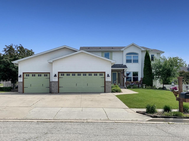 431 Limestone St, Kiel, WI 53042 - view of front facade with a garage, brick siding, a front yard, and driveway