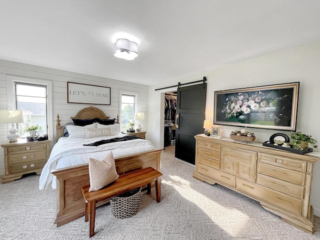 431 Limestone St, Kiel, WI 53042 - bedroom with light colored carpet, a walk in closet, a barn door, and a closet