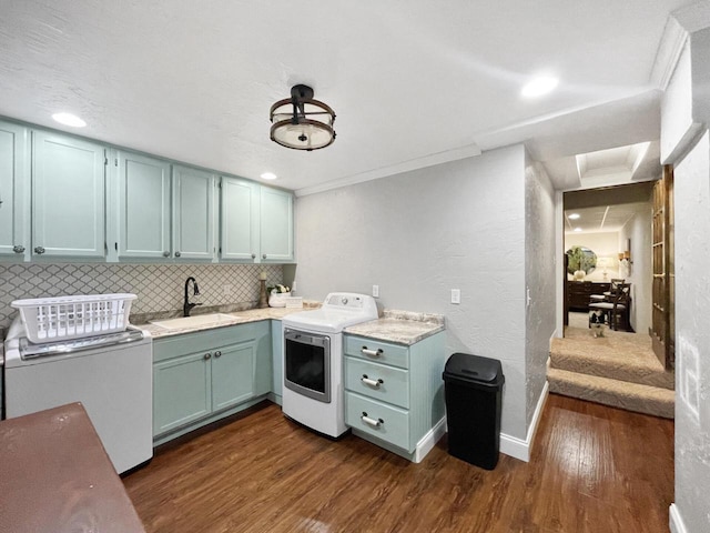 431 Limestone St, Kiel, WI 53042 - kitchen featuring washer / dryer, dark wood finished floors, decorative backsplash, light countertops, and blue cabinets