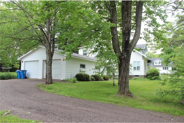 514 S Robert St, Grantsburg, WI 54840 - view of front of home with a front lawn, a garage, and a chimney