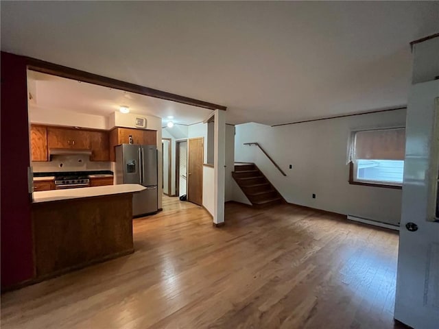 514 S Robert St, Grantsburg, WI 54840 - kitchen with stainless steel appliances, light wood-type flooring, a baseboard radiator, and brown cabinets