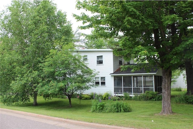 514 S Robert St, Grantsburg, WI 54840 - rear view of house with a sunroom and a yard