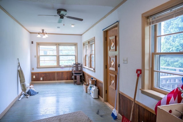 318 Tremont St, Mauston, WI 53948 - foyer with hardwood / wood-style flooring, plenty of natural light, ornamental molding, ceiling fan, and a wainscoted wall