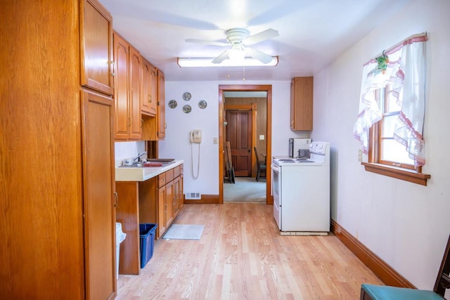 318 Tremont St, Mauston, WI 53948 - washroom with washer and clothes dryer, a ceiling fan, light wood-style flooring, and cabinet space