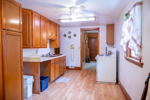 318 Tremont St, Mauston, WI 53948 - kitchen featuring range, brown cabinetry, light countertops, light wood finished floors, and a ceiling fan