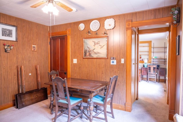 318 Tremont St, Mauston, WI 53948 - carpeted dining space with ceiling fan and wooden walls