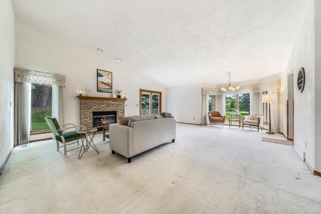 942 E Mayfield Dr, Appleton, WI 54911 - living room featuring a brick fireplace, carpet floors, a chandelier, and vaulted ceiling
