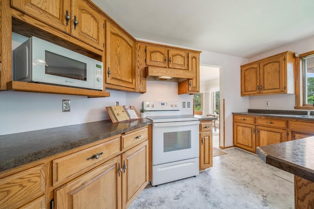 942 E Mayfield Dr, Appleton, WI 54911 - kitchen with white appliances, under cabinet range hood, plenty of natural light, and dark countertops
