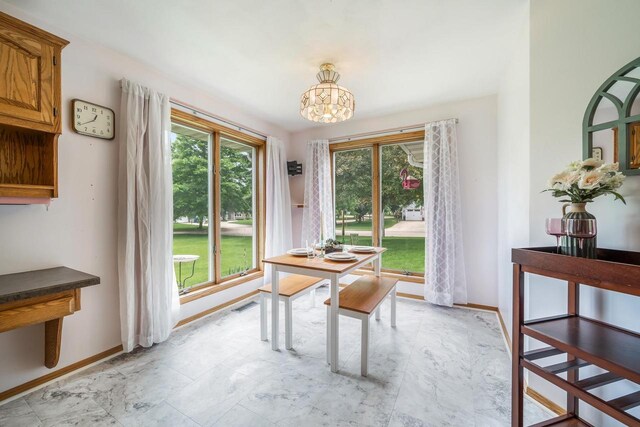 942 E Mayfield Dr, Appleton, WI 54911 - dining area with a chandelier and baseboards