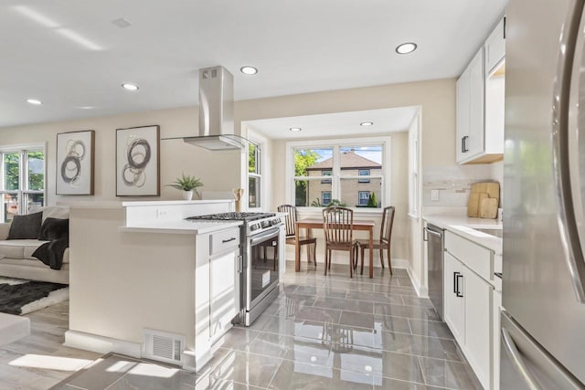 3700 S 21st St, Milwaukee, WI 53221 - kitchen featuring appliances with stainless steel finishes, exhaust hood, plenty of natural light, light countertops, and recessed lighting
