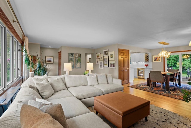 5706 Tolman Ter, Madison, WI 53711 - living room featuring light wood-style floors, a chandelier, and wine cooler