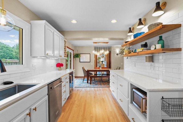 5706 Tolman Ter, Madison, WI 53711 - kitchen with appliances with stainless steel finishes, white cabinets, backsplash, light wood-type flooring, and recessed lighting