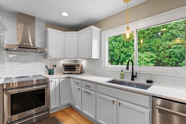 5706 Tolman Ter, Madison, WI 53711 - kitchen with appliances with stainless steel finishes, wall chimney range hood, backsplash, and light countertops