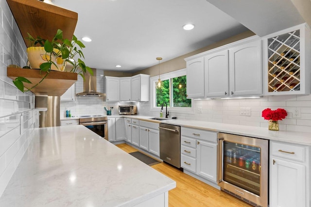 5706 Tolman Ter, Madison, WI 53711 - kitchen featuring beverage cooler, appliances with stainless steel finishes, wall chimney exhaust hood, decorative backsplash, and decorative light fixtures