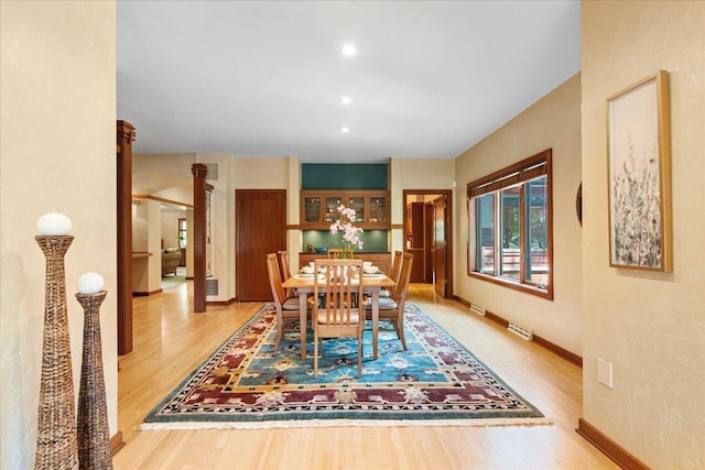 5870 Persimmon Dr, Fitchburg, WI 53711 - dining room featuring light wood finished floors, decorative columns, and recessed lighting